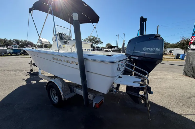 Slide: The Image of 2013 Sea Hunt XP 19 boat with Yamaha engine on trailer, parked outdoors. - 8