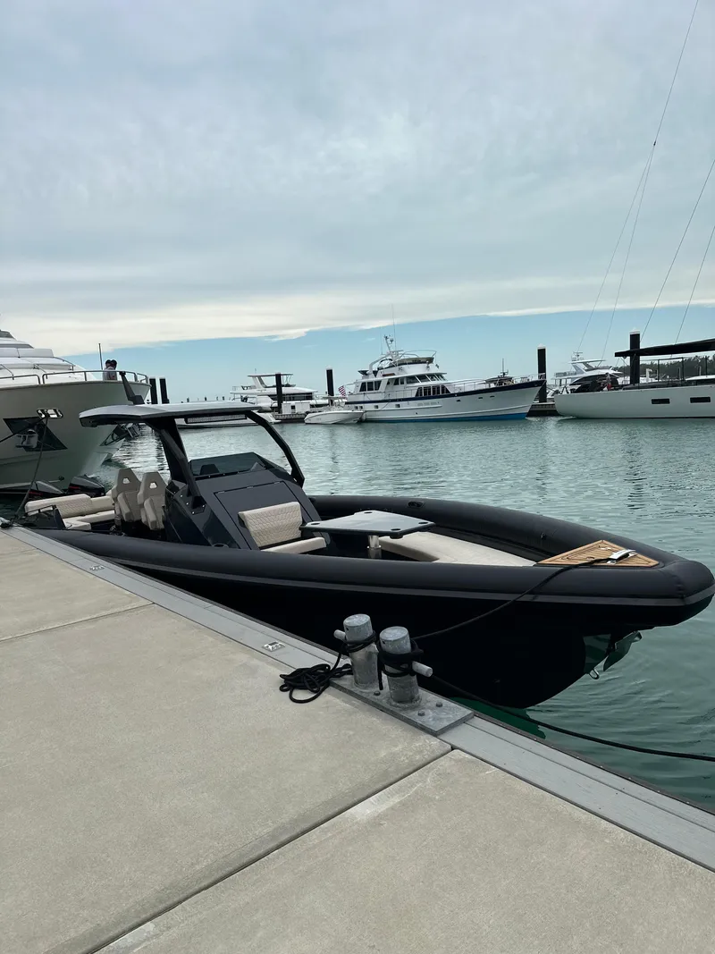 Slide: The Image of 2024 Skipper-BSK 38 boat docked at a marina with other yachts in the background. - 2