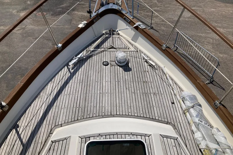 Slide: The Image of Deck of 1987 Nauticat 38 sailboat with wooden railings and fittings. - 16