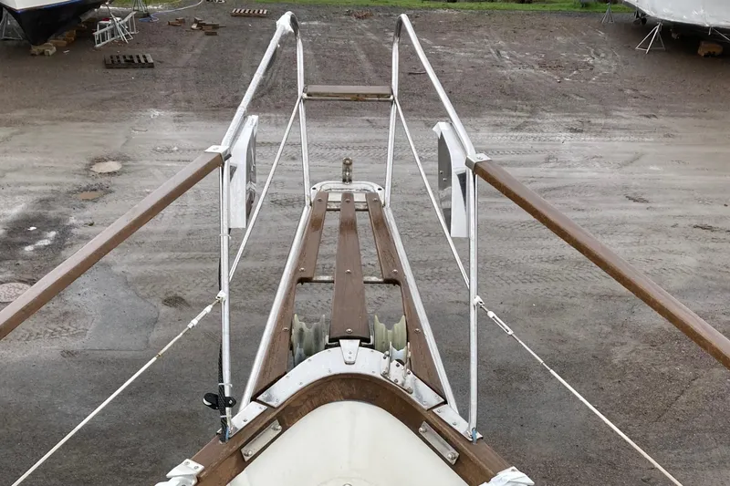 Slide: The Image of Bow view of 1987 Nauticat 38 sailboat on dry dock, showcasing deck and railings. - 17