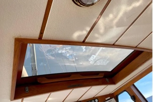 Slide: The Image of Interior view of 1987 Nauticat 38 sailboat with wooden ceiling and skylight. - 25
