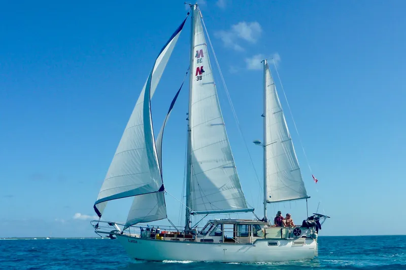Slide: The Image of 1987 Nauticat 38 sailboat cruising on open sea under clear blue sky. - 3