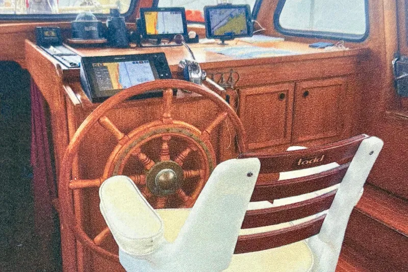 Slide: The Image of 1987 Nauticat 38 yacht helm with wooden wheel and navigation equipment. - 42