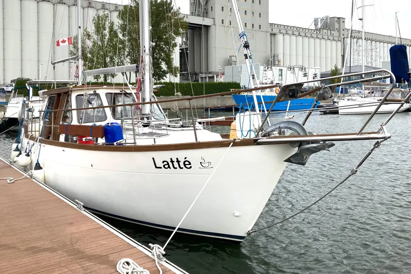 Slide: The Image of 1987 Nauticat 38 sailboat named "Latté" docked in a marina. - 5