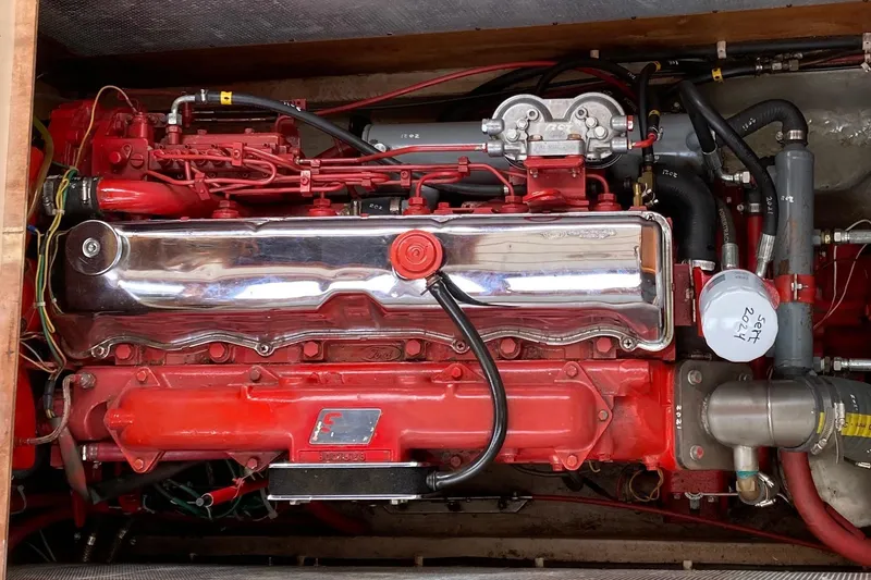 Slide: The Image of Engine of a 1987 Nauticat 38 sailboat, featuring a red and chrome design. - 50