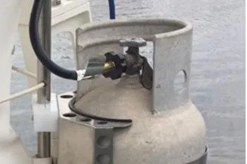 Slide: The Image of Propane tank on 1987 Nauticat 38 boat, connected and secured by a hose. - 61