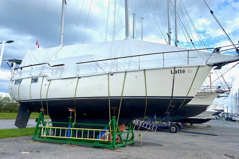 Slide: The Image of 1987 Nauticat 38 sailboat named "Latté" on dry dock, covered and secured. - 69