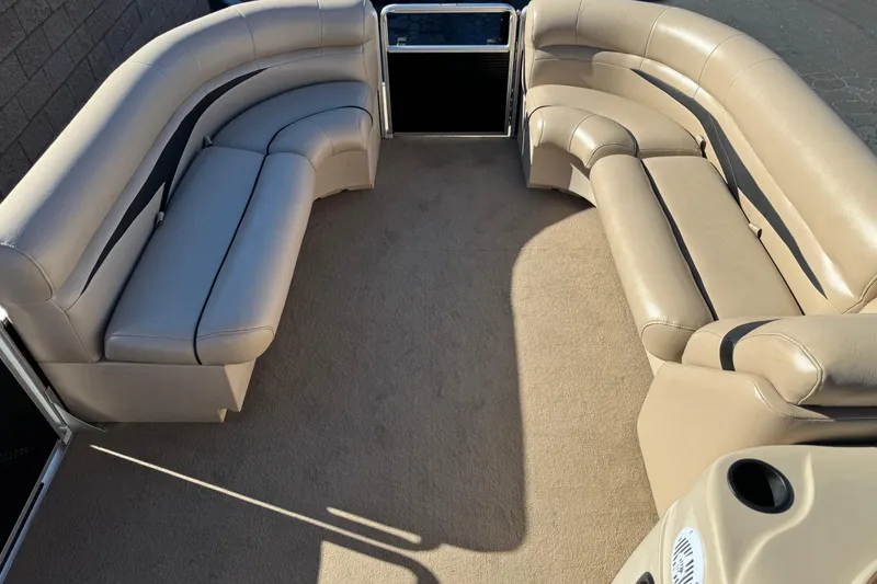 Slide: The Image of 2011 Harris Cruiser 220 CX pontoon boat interior with beige seating and carpet. - 10