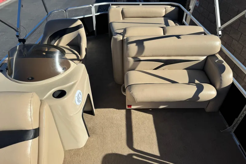 Slide: The Image of 2011 Harris Cruiser 220 CX interior with beige seating and helm, showcasing spacious layout. - 13