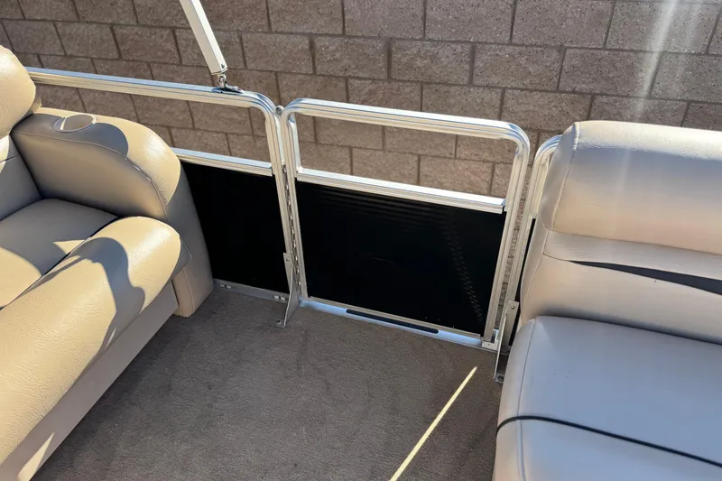 Slide: The Image of 2011 Harris Cruiser 220 CX interior with beige seating and metal railing. - 14