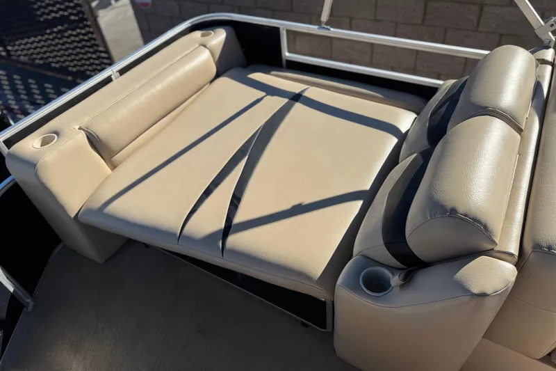 Slide: The Image of 2011 Harris Cruiser 220 CX boat interior with beige seating and cup holders. - 16