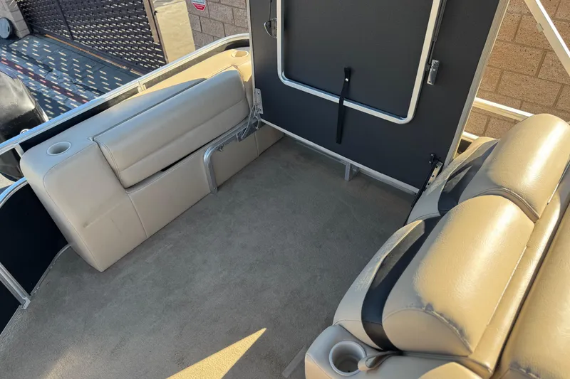 Slide: The Image of 2011 Harris Cruiser 220 CX boat interior with beige seating and cup holders. - 17