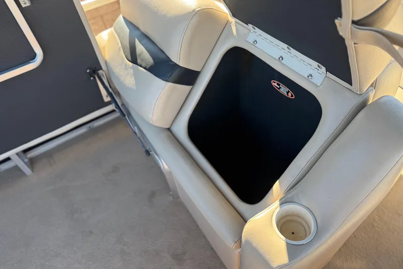 Slide: The Image of 2011 Harris Cruiser 220 CX boat seat with open storage compartment and cup holder. - 18