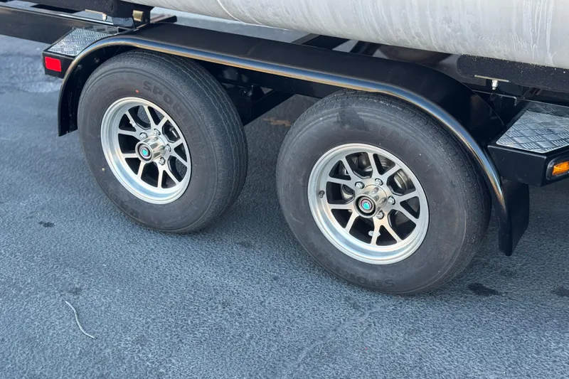 Slide: The Image of Trailer wheels of a 2011 Harris Cruiser 220 CX on asphalt surface. - 26