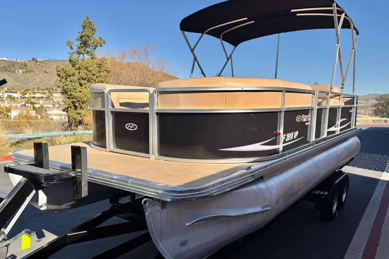 Slide: The Image of 2011 Harris Cruiser 220 CX pontoon boat on trailer, scenic background. - 3