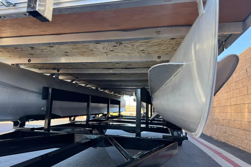 Slide: The Image of Underneath view of a 2011 Harris Cruiser 220 CX pontoon boat on a trailer. - 4