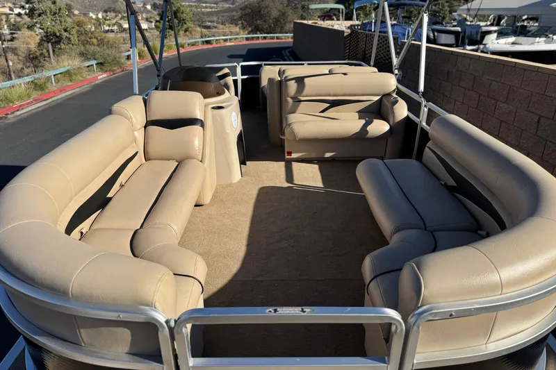 Slide: The Image of 2011 Harris Cruiser 220 CX pontoon boat with beige seating and spacious deck. - 9