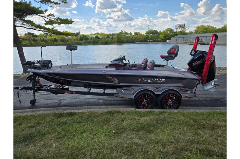 Slide: The Image of 2022 Vexus VX20 boat on trailer by a lake, under a partly cloudy sky. - 10