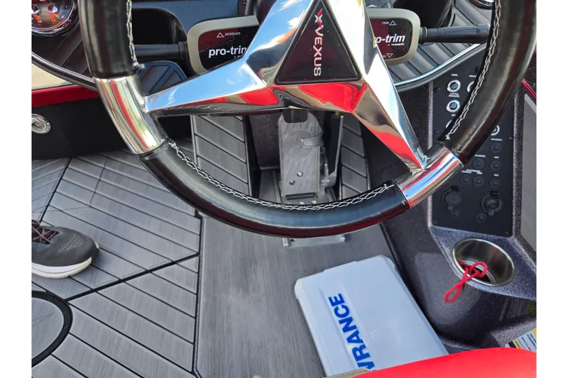 Slide: The Image of 2022 Vexus VX20 boat cockpit with steering wheel and control panel. - 13