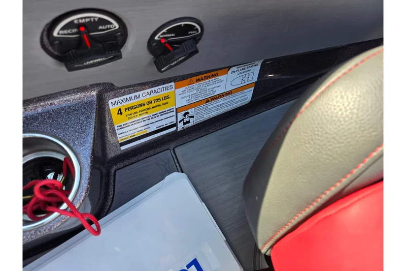 Slide: The Image of 2022 Vexus VX20 boat interior showing capacity warning label and controls. - 14