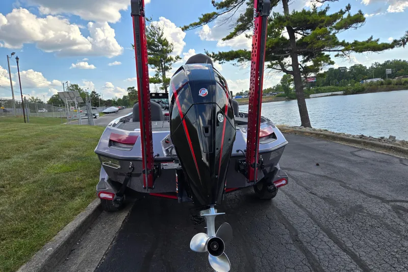 Slide: The Image of 2022 Vexus VX20 boat with outboard motor, parked near a scenic lakeside. - 2