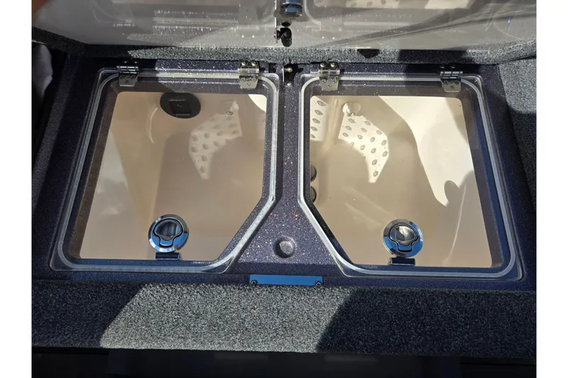 Slide: The Image of 2022 Vexus VX20 boat storage compartments with clear lids and secure latches. - 23