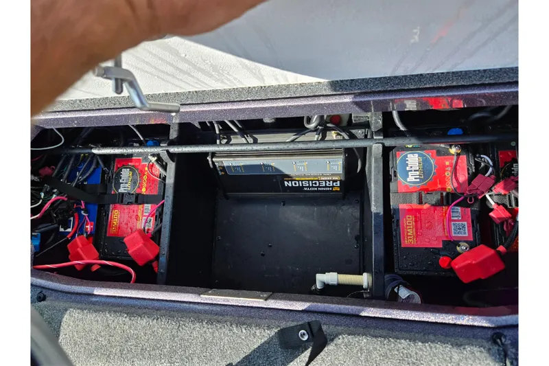 Slide: The Image of 2022 Vexus VX20 boat battery compartment with multiple batteries and wiring. - 25