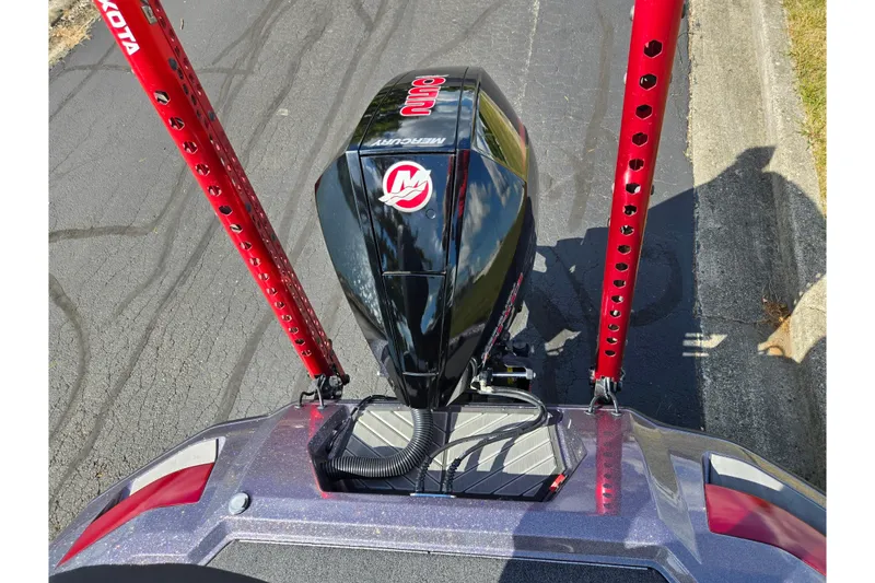 Slide: The Image of 2022 Vexus VX20 boat with Mercury engine and red Minn Kota poles on pavement. - 26