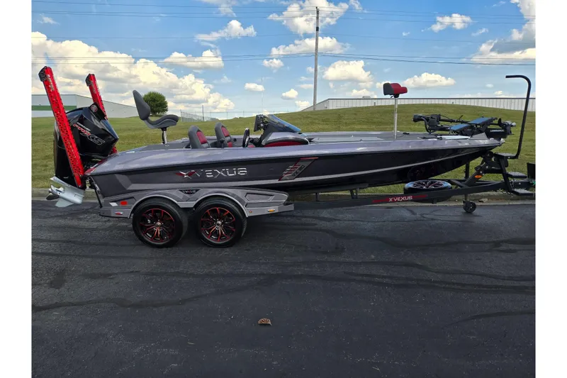 Slide: The Image of 2022 Vexus VX20 boat on trailer, sleek design, dual axles, outdoor setting. - 4