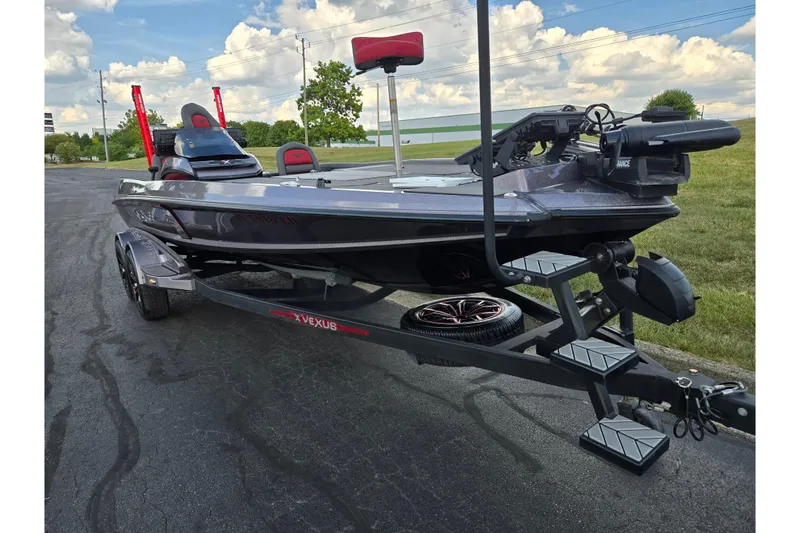 Slide: The Image of 2022 Vexus VX20 boat on trailer, parked outdoors under a partly cloudy sky. - 5