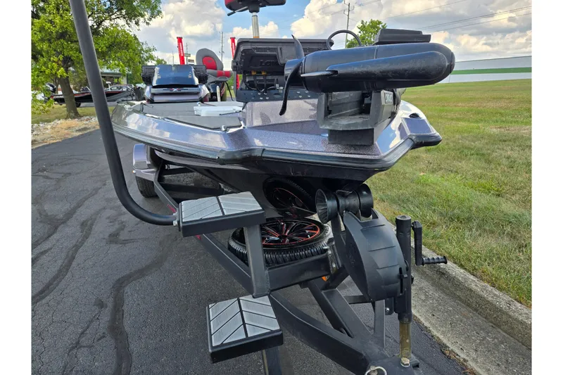 Slide: The Image of 2022 Vexus VX20 boat on trailer, parked on asphalt near grassy area. - 6