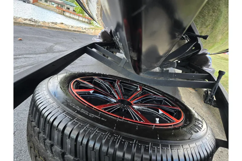 Slide: The Image of 2022 Vexus VX20 boat trailer with stylish red and black wheel design. - 7