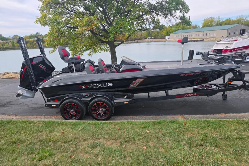 Slide: The Image of 2022 Vexus VX20 boat on trailer by a lake, featuring sleek design and modern features. - 10