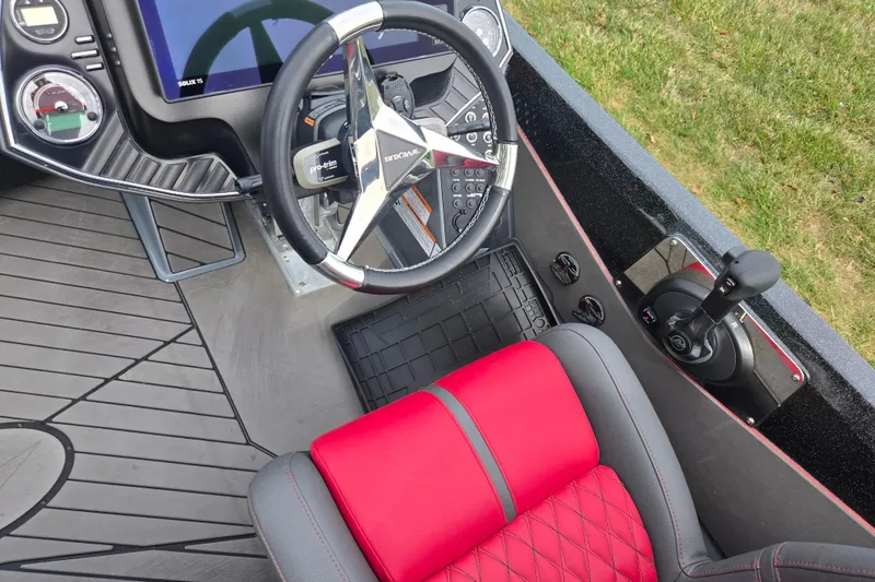 Slide: The Image of 2022 Vexus VX20 boat interior with steering wheel and red seat. - 12