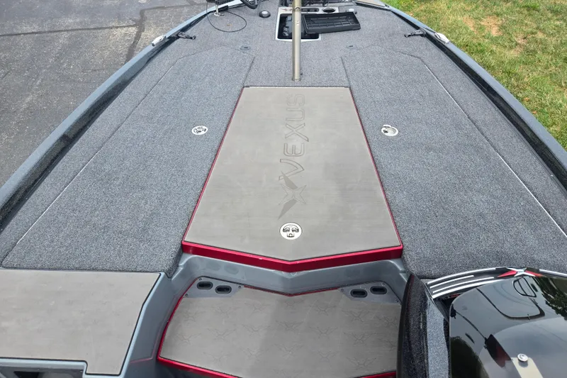Slide: The Image of 2022 Vexus VX20 boat deck with carpeted surface and storage compartments. - 14
