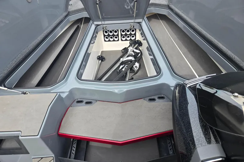 Slide: The Image of 2022 Vexus VX20 boat storage compartment with organized rod holders and equipment. - 15