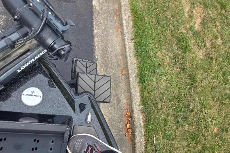 Slide: The Image of 2022 Vexus VX20 boat with Lowrance equipment, parked near grass and pavement. - 17