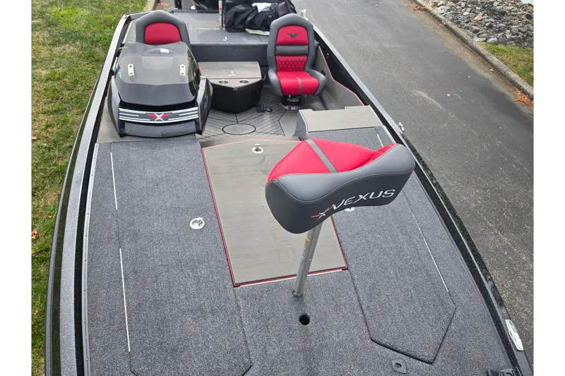 Slide: The Image of 2022 Vexus VX20 boat interior with red and gray seating, sleek design, and spacious deck. - 18