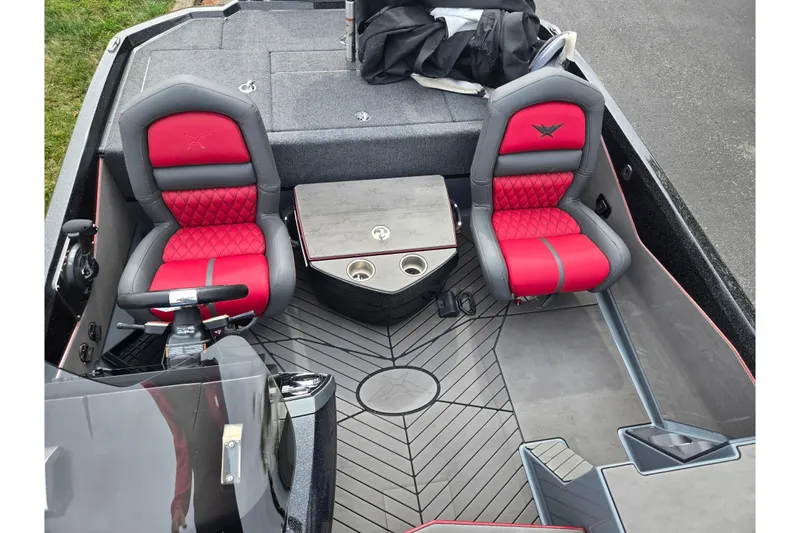 Slide: The Image of 2022 Vexus VX20 boat interior with red and gray seats, steering wheel, and storage compartments. - 20