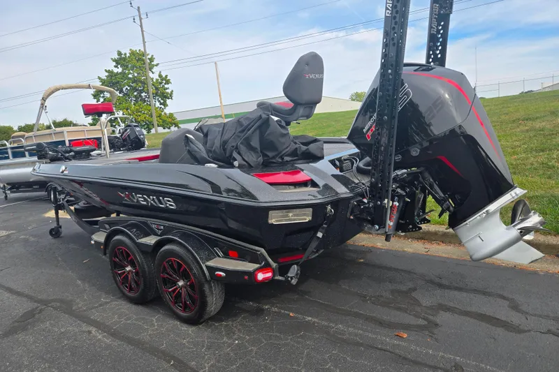 Slide: The Image of 2022 Vexus VX20 boat with Mercury engine, parked on pavement, featuring sleek black design. - 3