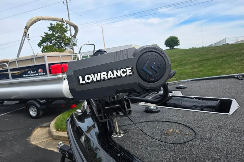 Slide: The Image of 2022 Vexus VX20 boat with Lowrance equipment, parked near a Sun Tracker pontoon. - 5
