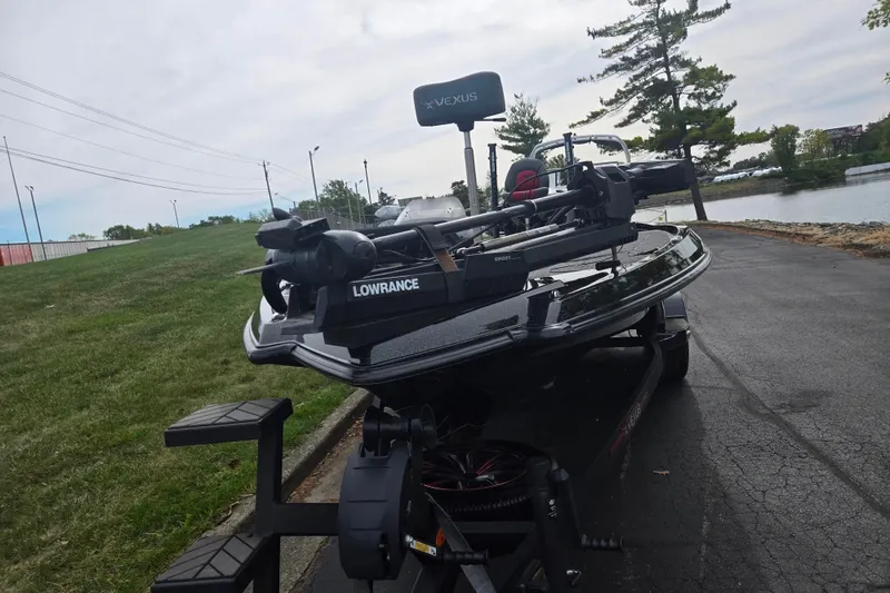 Slide: The Image of 2022 Vexus VX20 boat with Lowrance equipment on a trailer by a lakeside road. - 7