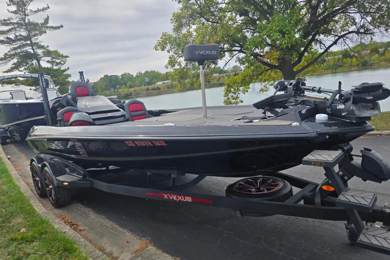 Slide: The Image of 2022 Vexus VX20 boat on trailer by a lakeside, featuring sleek design and modern equipment. - 9