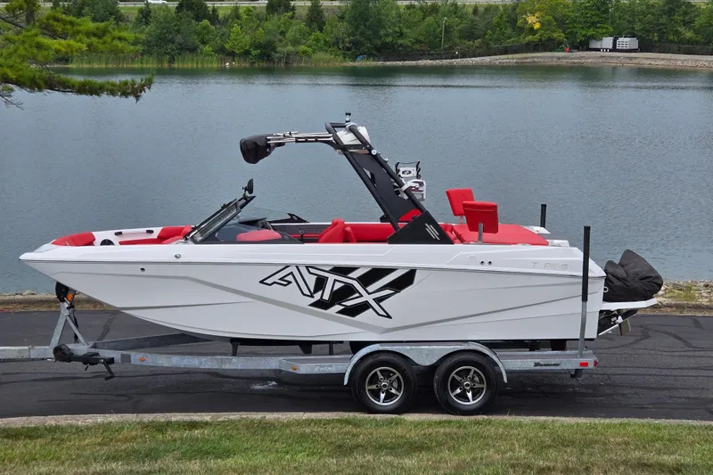 The Image of 2022 ATX Surf Boats 20 Type-S on trailer by a lake. - 0