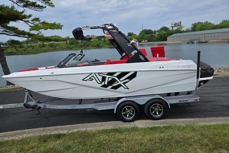 Slide: The Image of 2022 ATX Surf Boats 20 Type-S on trailer by a lake, featuring sleek design. - 10