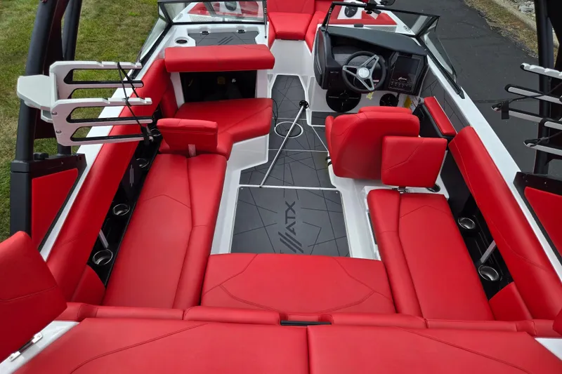 Slide: The Image of 2022 ATX Surf Boats 20 Type-S interior with vibrant red seating and modern dashboard. - 12