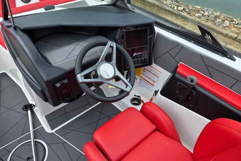 Slide: The Image of 2022 ATX Surf Boats 20 Type-S interior with red seating and modern dashboard. - 16