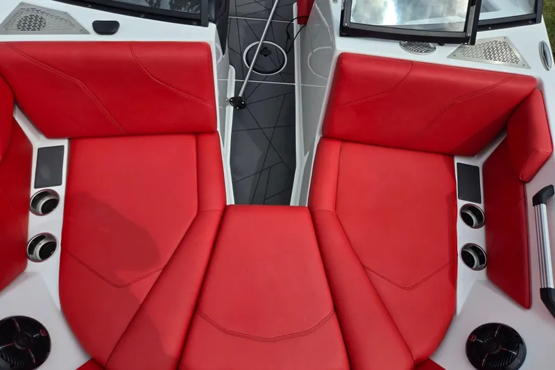 Slide: The Image of 2022 ATX Surf Boats 20 Type-S interior with vibrant red seating and modern design. - 18
