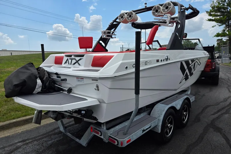 Slide: The Image of 2022 ATX Surf Boats 20 Type-S on trailer, featuring sleek design and vibrant red seating. - 3