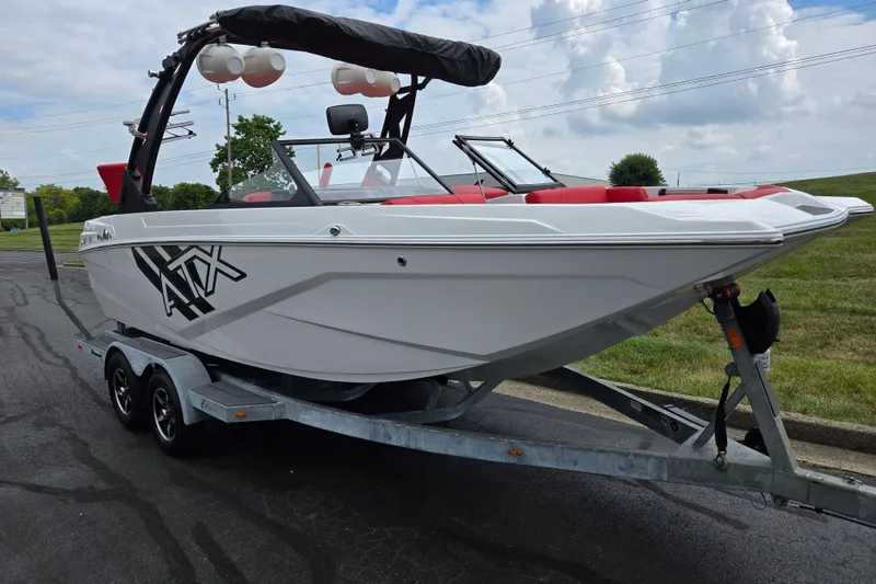 Slide: The Image of 2022 ATX Surf Boats 20 Type-S on trailer, white with red interior, parked outdoors. - 5